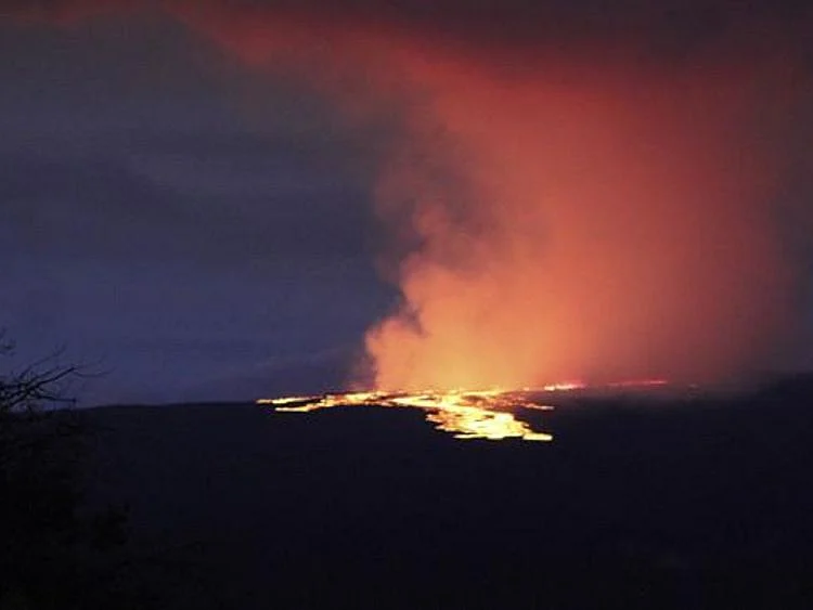 Lava pours out of the summit crater of Mauna Loa about 6:35 a.m. Monday, Nov. 28, 2022