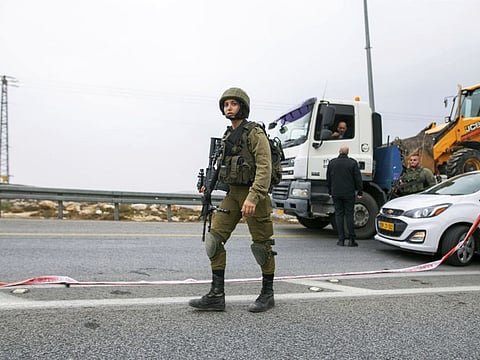 An Israeli soldier at the scene where a Palestinian man rammed his car into an Israeli soldier, seriously injuring her, before he was shot dead by Israeli police in the West Bank, on November 29, 2022.  