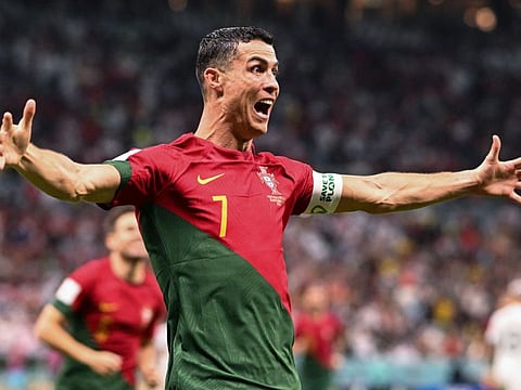 Portugal's forward Cristiano Ronaldo celebrates after scoring his team's first goal against Uruguay at the Lusail Stadium.