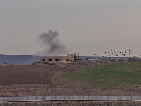 Smoke rises from a building after a shelling hit targets near the northern Syrian village of Zor Magar, as seen from the Turkish border town of Karkamis in Gaziantep province, Turkey, November 29, 2022. 