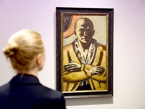 A woman looks at a self-portrait of German artist Max Beckmann 'Selbstbildnis gelb-rosa 1943 Amsterdam' in Berlin, Germany.