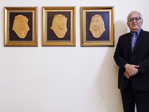 Pakistani medallion portrait artist Khalil Najmi standing alongside his wood-carved portraits of the UAE leaders which he says is a “gift from Pakistan to UAE” on the 51st National Day of UAE. 