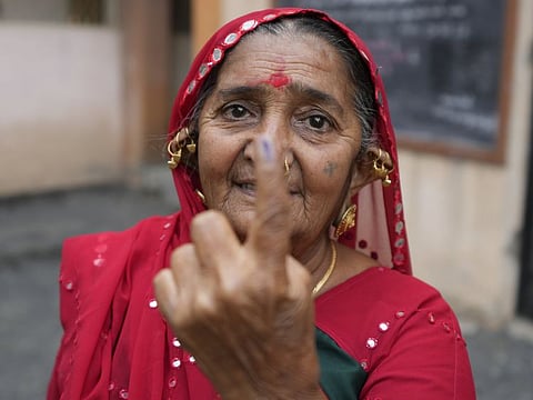 A woman shows her inked finger after casting her vote during the first phase of Gujarat state legislature elections in Limbadi, India, Thursday, Dec. 1, 2022.  