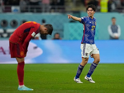 Japan's Ao Tanaka celebrates after scoring his side's second goal during the World Cup group E soccer match between Japan and Spain, at the Khalifa International Stadium in Doha, Qatar.