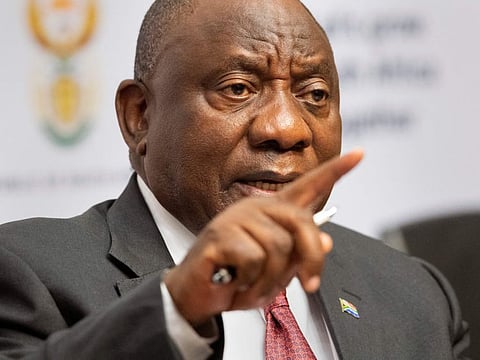 In this file photo taken on June 10, 2022 South African President Cyril Ramaphosa, gestures as he addresses a media conference, in the South African Parliament in Cape Town.