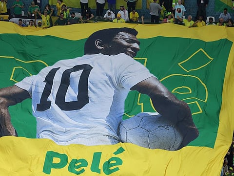 A large flag of Brazil legend Pele is unveiled in the crowd ahead of the Qatar 2022 World Cup Group G match between Cameroon and Brazil at the Lusail Stadium in Lusail, north of Doha.