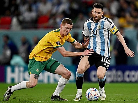 Argentina's Lionel Messi (right) is challenged by Australia's defender Kye Rowles during the Qatar World Cup round of 16 match at the Ahmad Bin Ali Stadium in Al Rayyan, west of Doha on December 3, 2022. 