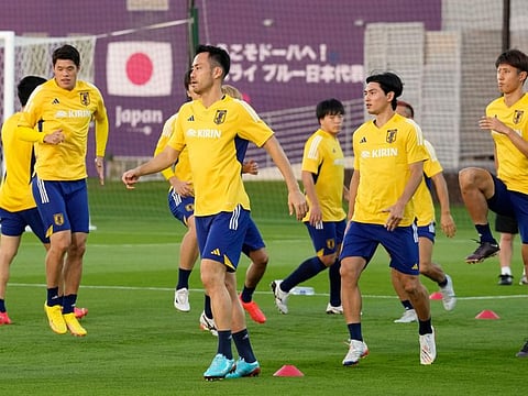 Japan players warm up during a training session in Doha, Qatar.