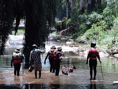 Rescue workers search the waters of the Jukskei river in Johannesburg.  Congregations often gather to conduct church rituals including cleansing and baptism along the Jukskei river which runs along many townships including Alexandra in the east of Johannesburg.
