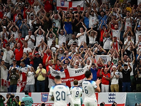 England players celebrate with their fans after they won the Qatar 2022 World Cup round of 16 football match against Senegal at the Al-Bayt Stadium in Al Khor, north of Doha. They face France next in the quarter-finals on Saturday.