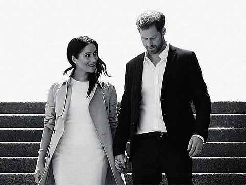 This image released by Netflix shows Prince Harry and Meghan, Duke and Duchess of Sussex, in a scene from the documentary "Harry & Meghan"