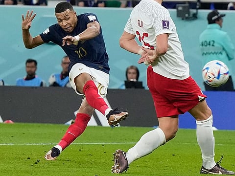 Kylian Mbappe scores France’s second goal against Poland in the FIFA World Cup Qatar 2022  Round of 16 match at the Al Thumama Stadium in Doha, Qatar, on December 4, 2022. Mbappe leads the scoring chart with five goals. 