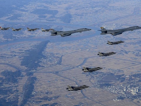 In this photo provided by South Korean Defence Ministry, two US Air Force B-1B bombers, top center, four South Korean Air Force F-35 fighter jets and four US Air Force F-16 fighter jets fly over South Korea Peninsula during a joint air drill called "Vigilant Storm," in South Korea on Nov. 5, 2022.