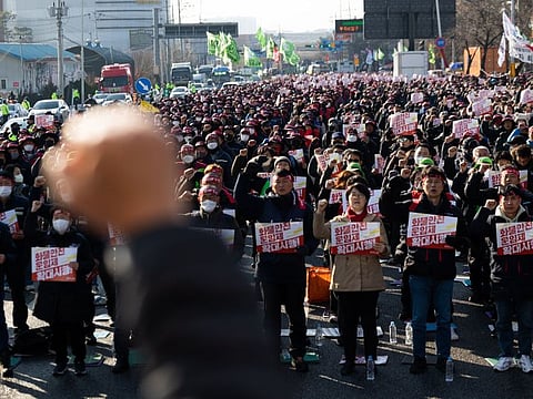 Members of the Korean Confederation of Trade Unions (KCTU) shout slogans during a protest in Uiwang, South Korea, on Tuesday, Dec. 6, 2022. A major umbrella union joined a protest by South Korean truckers, broadening a work stoppage that is disrupting global supply chains and hitting local exporters.