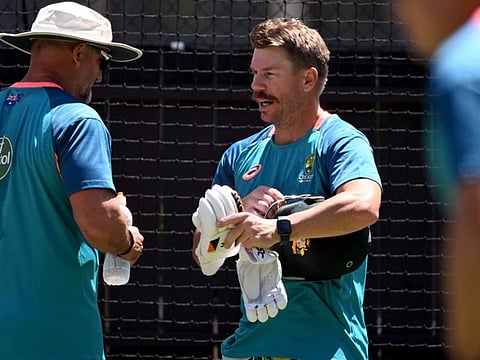 Australia's David Warner (centre) speaks with assistant coach Michael Di Venuto during a practice session at the Adelaide Oval ahead of the second Test against the West Indies on Wednesday.
