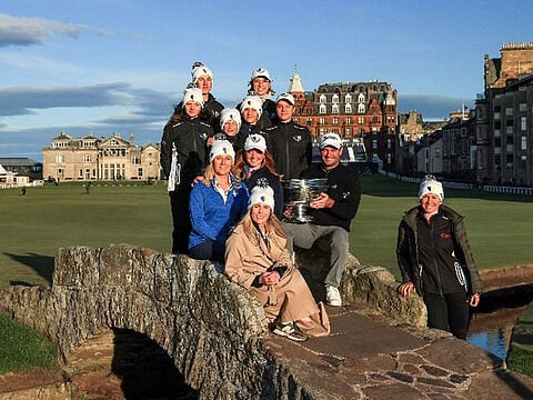 The Ukrainian National Golf Team, Veronika Rastvortseva and Toni Zverblis of Project Ukraine pose with Dunhill Links Champion Ryan Fox on the Swilcan Bridge in St Andrews