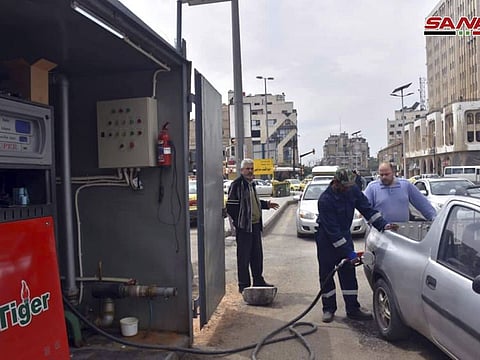 A worker filling a pickup at a gas station, in Homs, Syria. The Syrian government has decided to close state agencies for two days due to severe fuel shortages caused by disruption of supplies arrivals and Western sanctions imposed on President Bashar Al Assad’s government. 