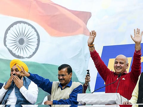 Delhi CM Arvind Kejriwal along with Punjab Chief Minister Bhagwant Mann and Delhi Deputy Chief Minister Manish Sisodia shows a victory sign after the MCD poll triumph, in New Delhi on Wednesday.  