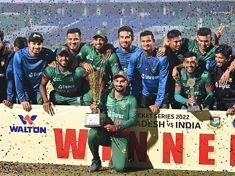 Bangladesh's players pose win the winners trophy at the end of the third and final one-day international (ODI) cricket match against India at the Zahur Ahmed Chowdhury Stadium in Chittagong.