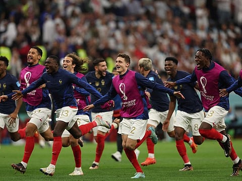 France's players celebrate at the end of the Qatar 2022 World Cup quarter-final match against England at the Al-Bayt Stadium in Al Khor, north of Doha.