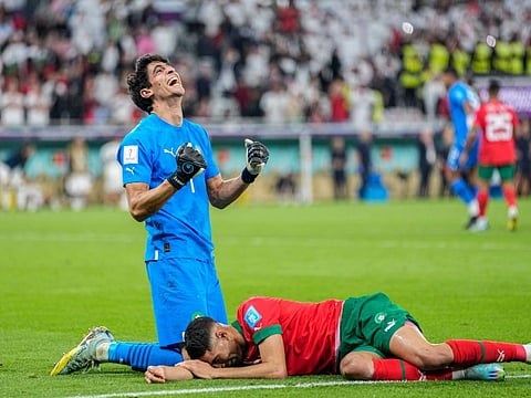 Morocco's goalkeeper Yassine Bounou (left) celebrates with his teammate Achraf Hakimi after their victory over Portugal during the World Cup quarterfinal at Al Thumama Stadium in Doha, Qatar.