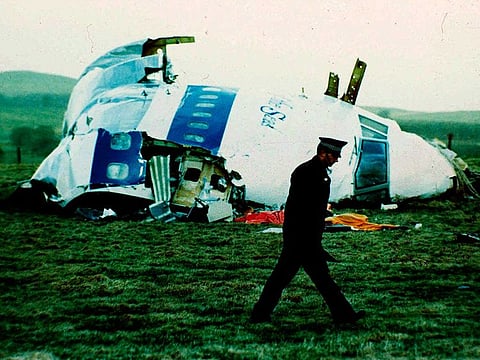 A police officer walks by the nose of Pan Am flight 103 in a field near the town of Lockerbie, Scotland where it lay after a bomb aboard exploded, killing a total of 270 people, Wednesday, Dec. 21, 1988. 