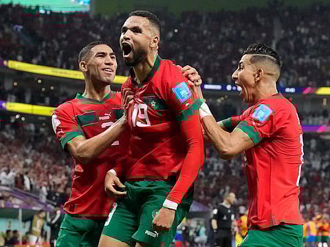 A HERO: Youssef En-Nesyri (centre) celebrates after scoring Morocco’s winning goal against Portugal in the FIFA World Cup Qatar 2022 quarterfinal football match at the Al Thumama Stadium in Doha on December 10, 2022. Morocco became the first African nation to enter the last four. 