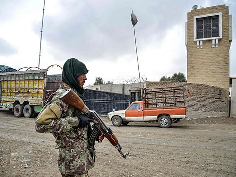 A Taliban security personnel stands guard at the Afghanistan-Pakistan border in Spin Boldak on December 12, 2022.