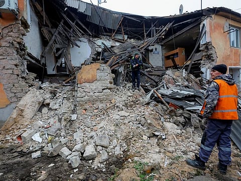Workers remove debris of a residential building heavily damaged in recent shelling in the course of Russia-Ukraine conflict in Horlivka (Gorlovka) in the Donetsk region, Russian-controlled Ukraine, December 13, 2022.