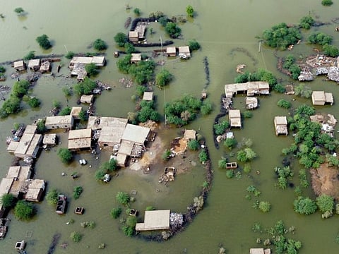 Homes are surrounded by floodwaters in Sohbat Pur city, a district of Pakistan's southwestern Balochistan province, on August 30.