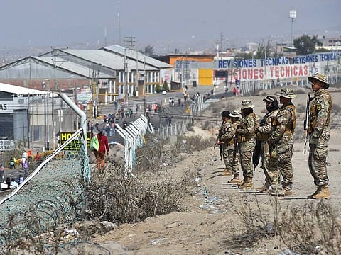 Soldiers stand guard after clearing a roadblock to the airport, created by supporters of ousted Peruvian President Pedro Castillo in Arequipa, Peru, Wednesday, Dec. 14, 2022. Castillo was detained on Dec. 7 after he was ousted by lawmakers when he sought to dissolve Congress ahead of an impeachment vote. 