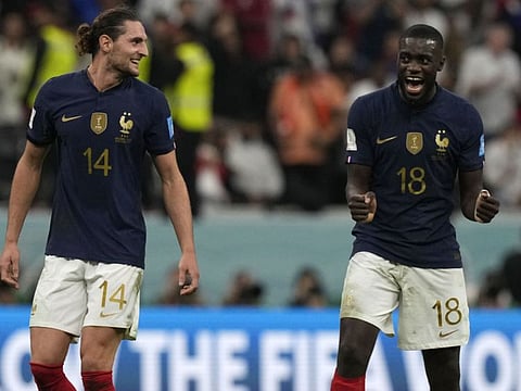 France's Dayot Upamecano (left) celebrates with Adrien Rabiot after the World Cup quarter-final win against England. Both players were isolated with flu-like symptoms.
