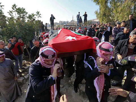 Jordanian military personnel join a funeral procession for a senior police officer who was killed in riots in the southern city of Jerash. 