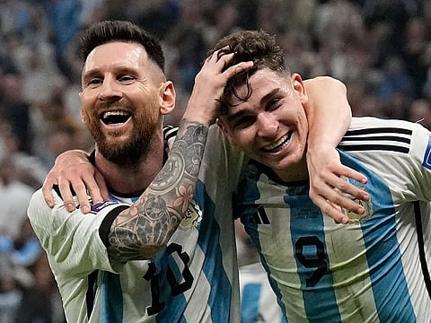 Argentina's Lionel Messi (left) and Julian Alvarez celebrate after scoring against Croatia in the FIFA World Cup Qatar 2022 football semifinal at the Lusail Stadium on December 13, 2022. Alvarez scored from a Messi assist. A repeat of that will be required for Argentina to beat France in the final on December 18, 2022. 