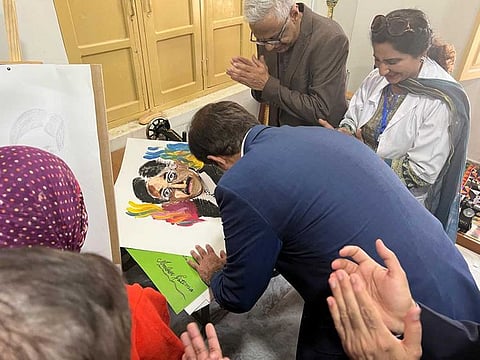 Sindh Chief Minister, Syed Murad Ali Shah, signs his portrait made by a female patient of Sir Cowasji Jahangir Institute of Psychiatry and Behavioural Sciences, Hyderabad.