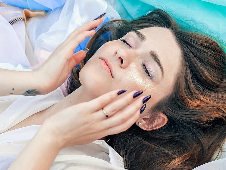 woman touching her face 