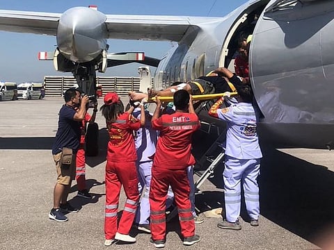 This handout photo taken on December 19, 2022 and released on December 20 by the Royal Thai Navy shows a survivor being carried on a stretcher at U-Tapao Royal Thai Navy Airfield in Rayong Province, as search and rescue operations continued in the Gulf of Thailand after the sinking of the HTMS Sukhothai warship.