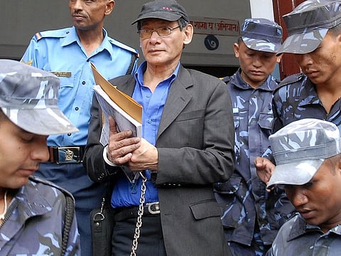 In this file photo taken on August 19, 2008 French serial killer Charles Sobhraj (C) is guided by Nepalese policemen towards a waiting vehicle after a court ruling in Kathmandu. 