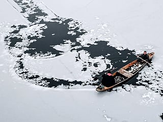 Look: World famous Dal Lake in Kashmir is frozen over. Exclusive pictures of little boats breaking ice to float
