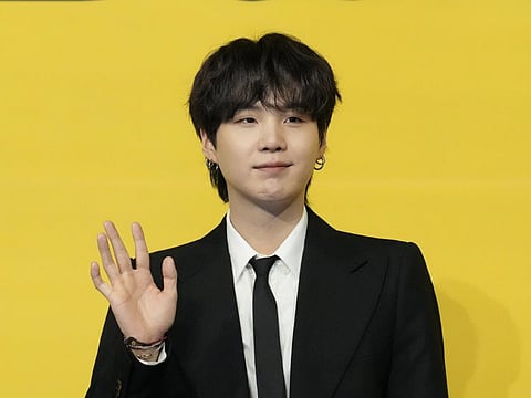 SUGA, a member of South Korean K-pop band BTS, poses for photographers ahead of a press conference to introduce their new single "Butter" in Seoul, South Korea, Friday, May 21, 2021.