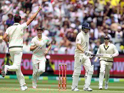 Joe Root walking back after being dismissed by Mitchell Starc.