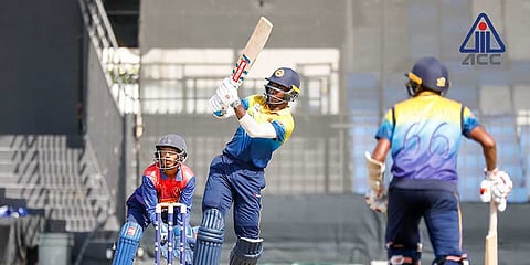 Sri Lankan opener Chamindu Wickramasinghe plays a lofted drive during his century against Nepal at the Sharjah Cricket Stadium on Sunday.