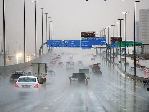 Motorists negotiate with poor visibility yesterday on Dubai-Al Ain Road as heavy rains lashed many parts of the UAE. According to the NCM, cloudy conditions will prevail until Saturday with likelihood of more rains.
