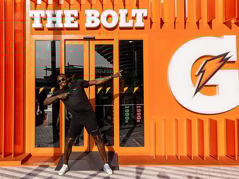 Usain Bolt poses for a picture outside the Bolt Pavilion during 'Run The World' at Expo 2020 Dubai.