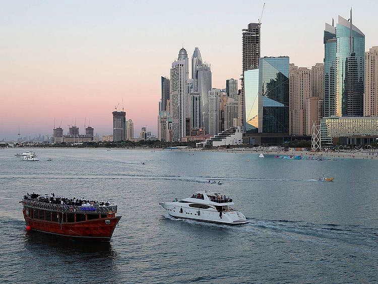 STOCK Dubai skyline economy tourists