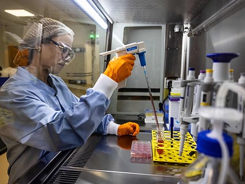An operator performs a manipulation under controlled atmosphere in an Urgo laboratory dedicated to the Genesis project at the Urgo site in Chenove, eastern France, on December 16, 2022. The company has launched the Genesis project, which consists of creating artificial skin to heal severe wounds.
