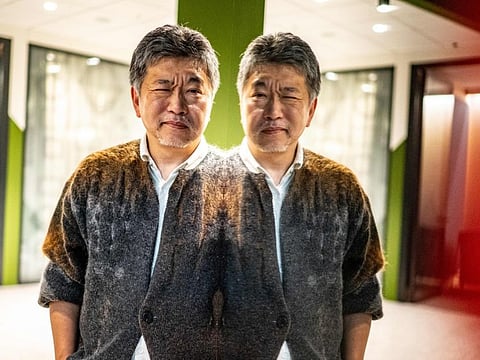 In this picture taken on December 9, 2022, Japanese director Hirokazu Kore-eda poses during a photo session following an interview with AFP in Tokyo.
