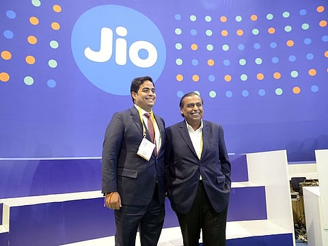 Mukesh Ambani, chairman of Reliance Industries Ltd., right, with his son Akash Ambani, chairman of Reliance Jio Infocomm.