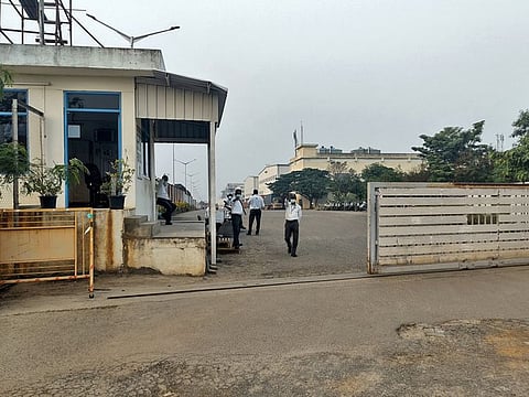 Private security guards stand at the entrance of a closed plant of Foxconn India unit.