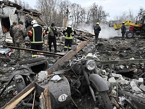 Rescuers clear debris of homes destroyed by a missile attack in the outskirts of Kyiv, on December 29, 2022, following a Russian missile strike on Ukraine.